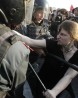 A participant is restrained by Russian riot police during the "march of the million" opposition protest in central Moscow